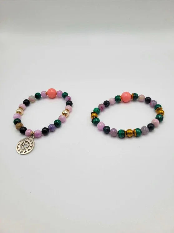 Colorful gemstone beaded bracelets with one featuring a silver charm, spiritual jewelry