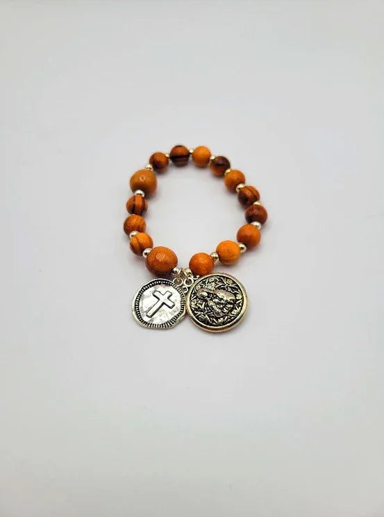 Wood bead bracelet with silver cross and coin charms on white background