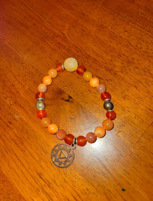Sterling silver Sacral Chakra bracelet with Carnelian, Fire Agate, and Sunstone beads, designed for healing energy and spiritual balance.