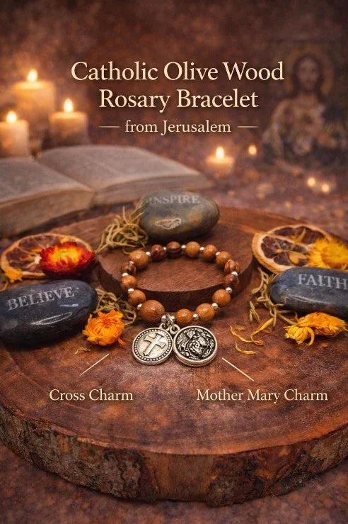 Catholic olive wood rosary bracelet with cross and Mother Mary charms, surrounded by faith stones and candles.