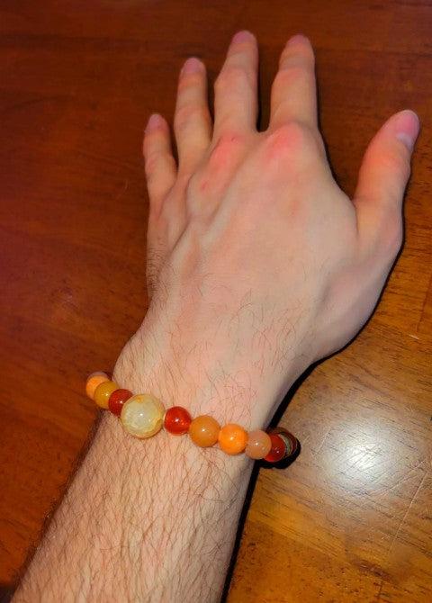 Sterling silver sacral chakra bracelet with carnelian, fire agate, and sunstone crystals, healing energy jewelry for women.
