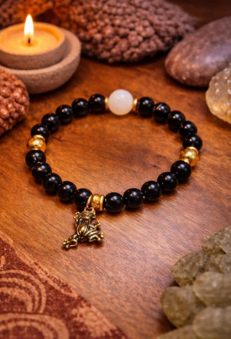 Black tourmaline and moonstone bracelet featuring beads with a polished finish, suitable for spiritual healing and energy protection.