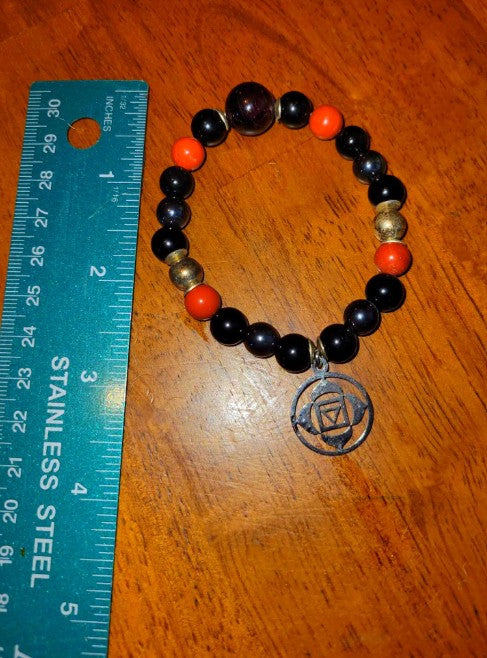 Root chakra healing bracelet featuring black tourmaline, obsidian, garnet, and sterling silver grounding crystals.