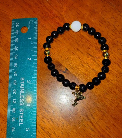 Black Tourmaline and Moonstone bracelet with beads, spiritual healing jewelry for energy protection and rebirth, suitable for gifting.