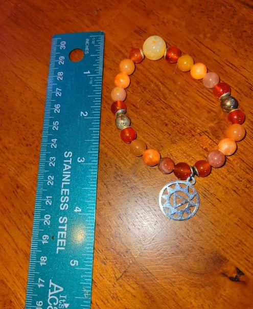 Sterling silver sacral chakra bracelet featuring carnelian, fire agate, and sunstone crystals, healing energy jewelry for women