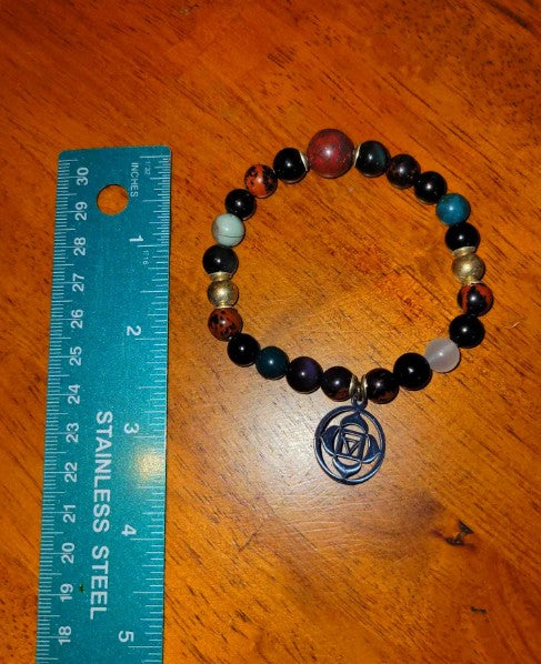 Root Chakra bracelet with rainbow obsidian, blood stone, and jet beads, featuring grounding healing energy jewelry.