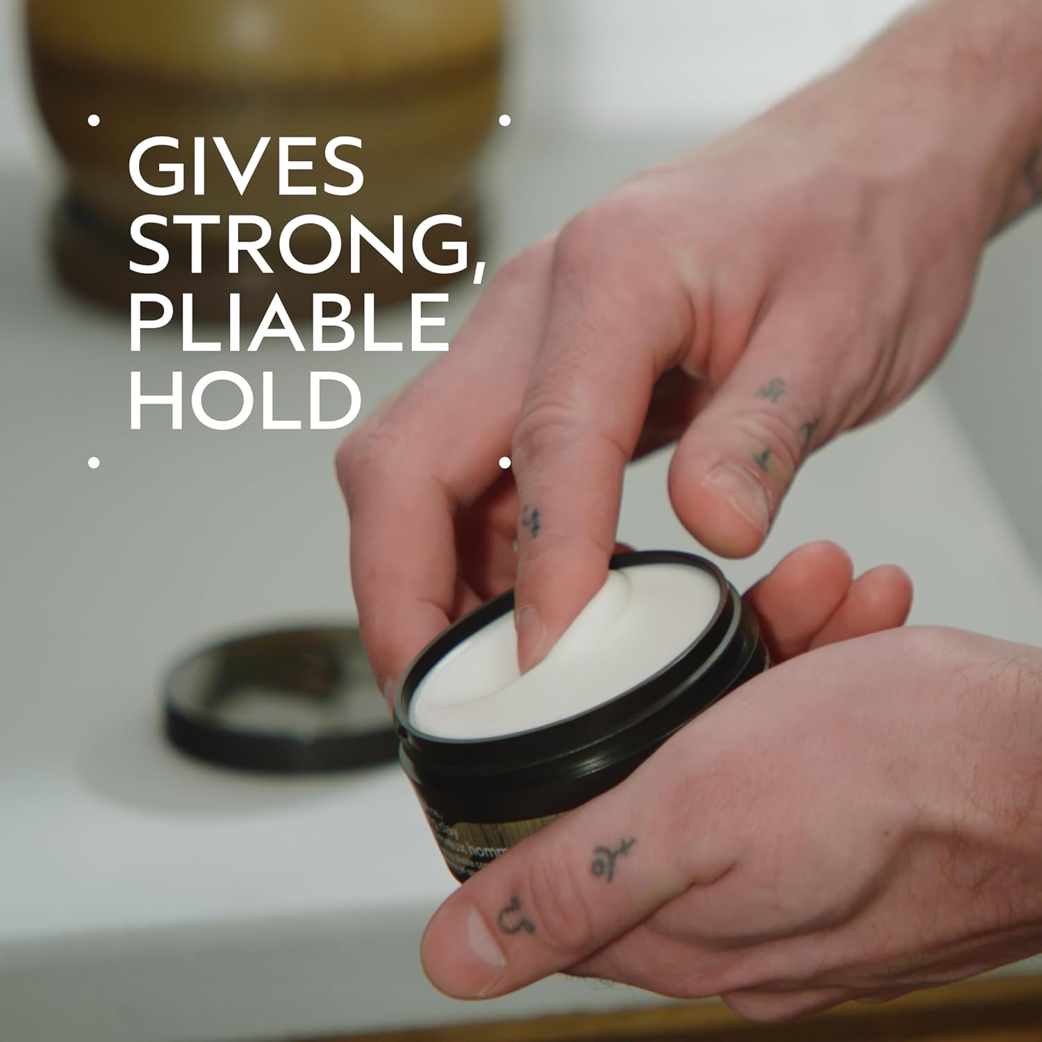 Aveda Men Pure-Formance Grooming Clay in 2.5 oz jar showing the matte finish and pliable hold, lightweight and naturally derived.