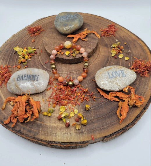 Sacral chakra bracelet featuring orange carnelian, fire agate, sunstone beads, sterling silver accents, healing energy jewelry for women.