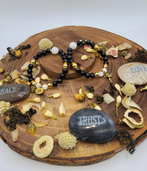 Black tourmaline and moonstone bracelet with spiritual healing and energy protection beads, ideal for gift or personal wellness.