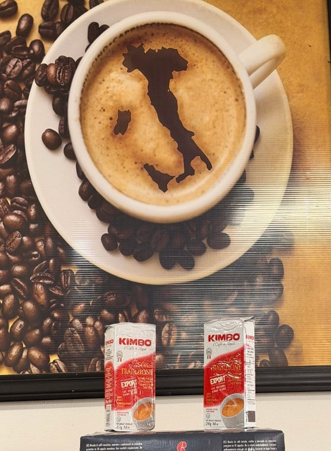 Italian coffee cup art with map of Italy in foam, Kimbo coffee packages and coffee beans